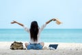 Lifestyle freelance woman raise arms relax after using laptop working on the beach.ÃÂ  Royalty Free Stock Photo